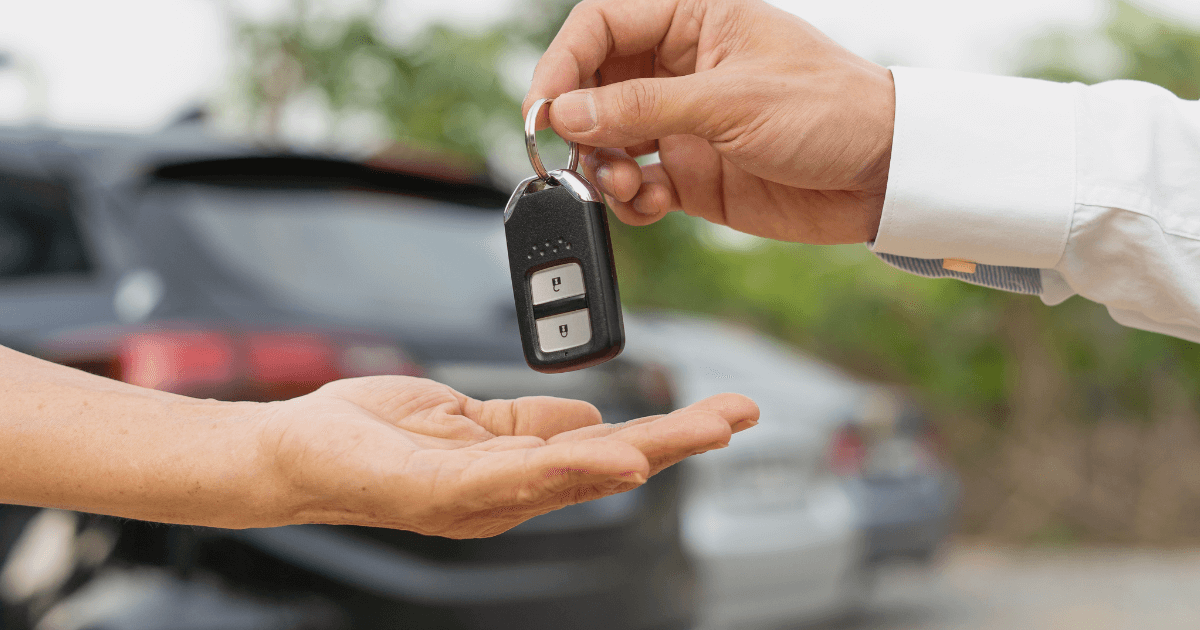 A dealer handing keys over to a customer